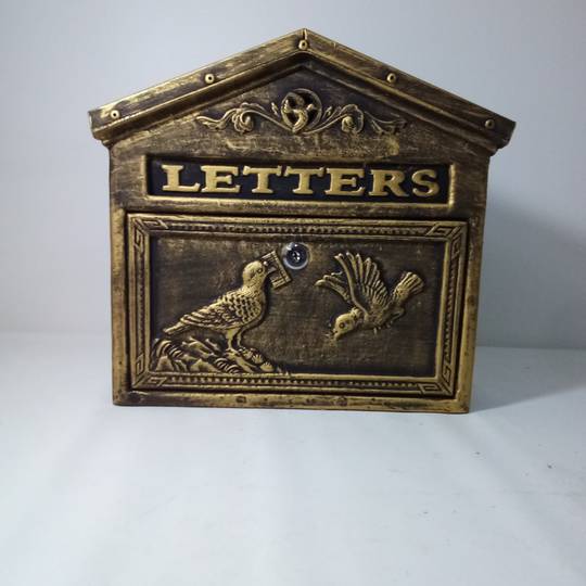 Antique cast iron mailbox for letters and postal mail in rust color birds